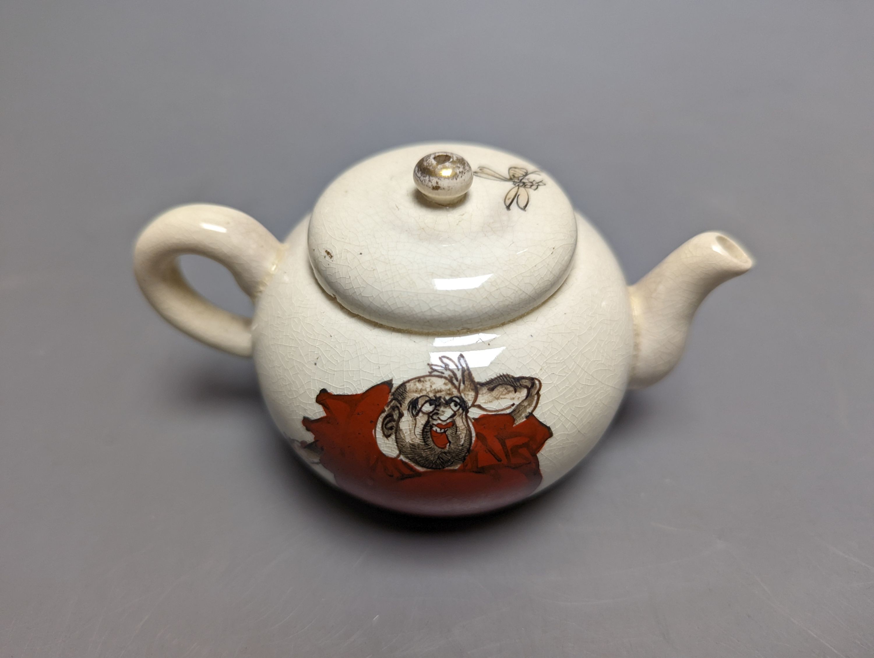 A Japanese pottery 'Daruma' teapot and pouring jug, circa 1900